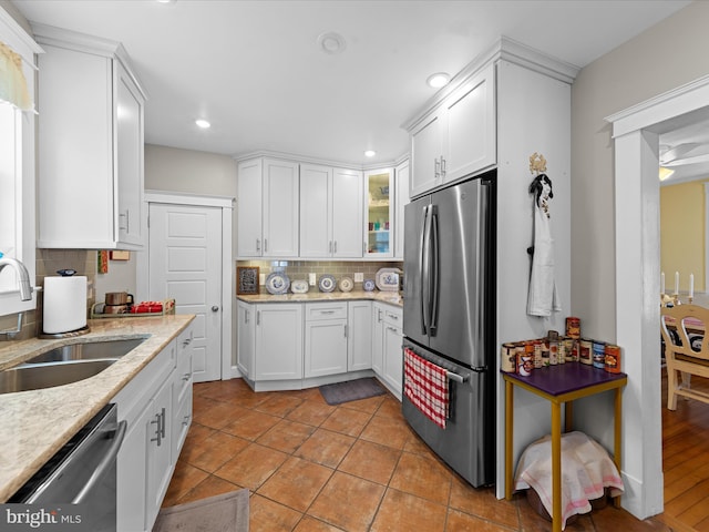 kitchen with a sink, white cabinets, and stainless steel appliances