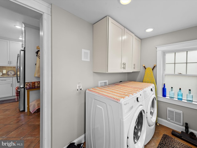 washroom with visible vents, baseboards, recessed lighting, cabinet space, and separate washer and dryer