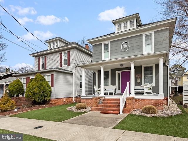 american foursquare style home featuring covered porch