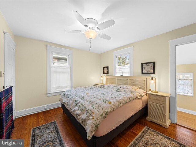 bedroom with baseboards, dark wood-style flooring, and ceiling fan