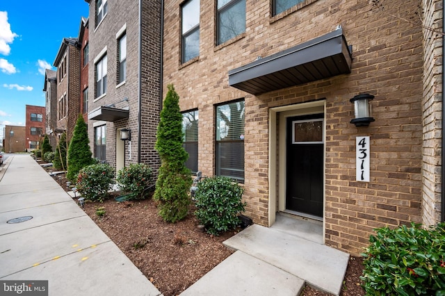 entrance to property with brick siding