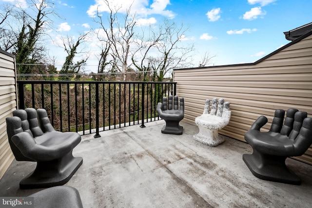 view of patio featuring a balcony