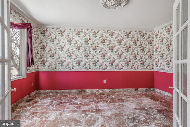 empty room with ornamental molding and french doors