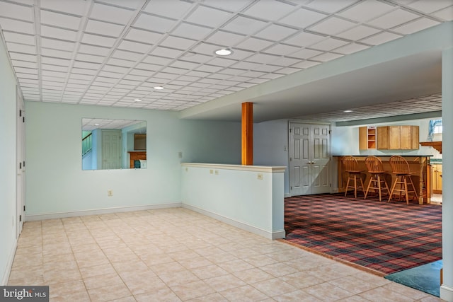 interior space featuring a bar, recessed lighting, and baseboards