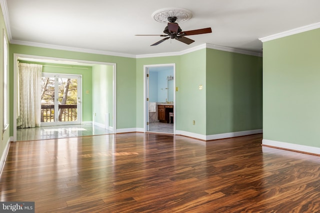 unfurnished room with baseboards, ornamental molding, ceiling fan, and wood finished floors