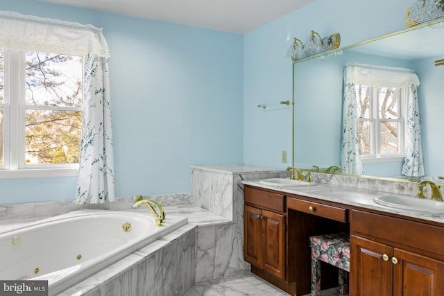 full bathroom with plenty of natural light, a tub with jets, and a sink