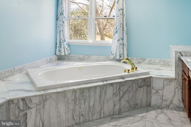 bathroom with vanity and a bath