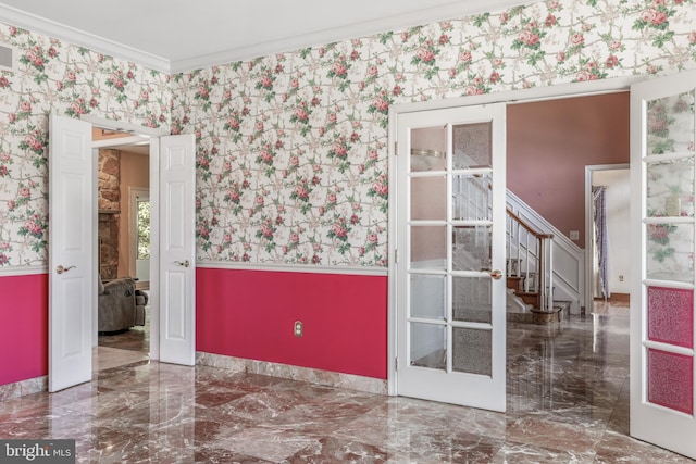 unfurnished room with ornamental molding, marble finish floor, stairway, and wallpapered walls