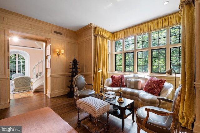 interior space featuring recessed lighting, a decorative wall, wood finished floors, visible vents, and stairway