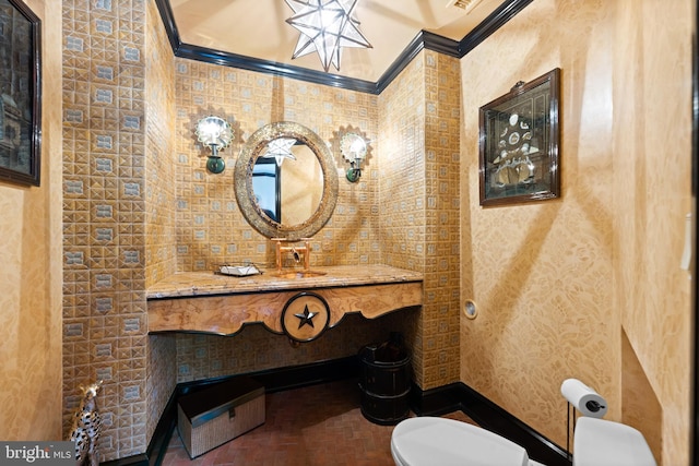 half bath with visible vents, crown molding, vanity, and toilet