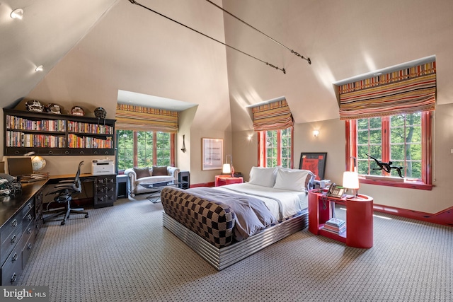 bedroom featuring high vaulted ceiling, multiple windows, carpet, and built in study area