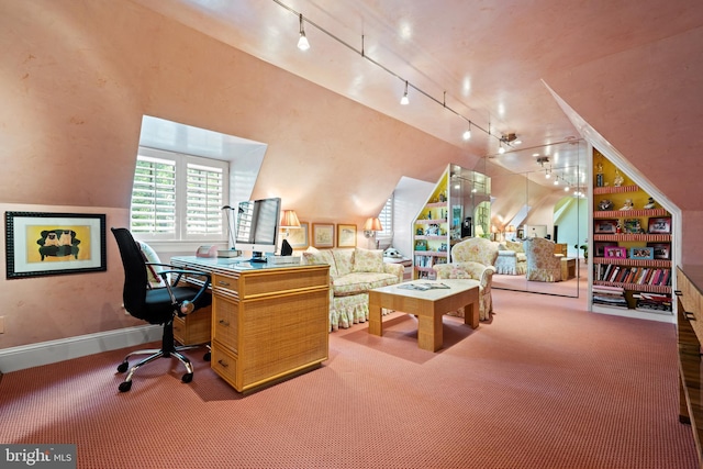 carpeted office space featuring track lighting, vaulted ceiling, and baseboards