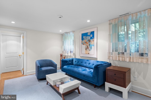 living area with a wealth of natural light, visible vents, baseboards, and recessed lighting