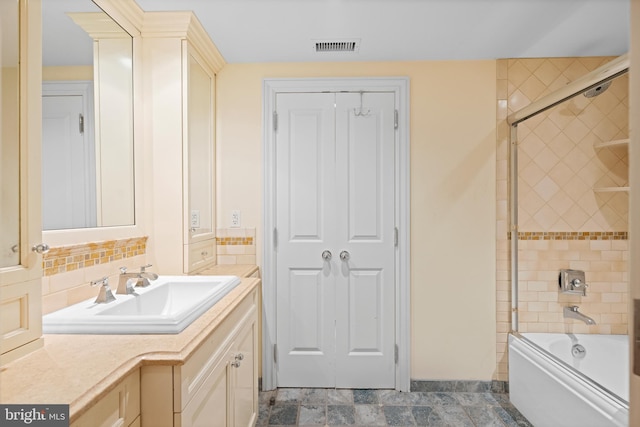 full bathroom featuring enclosed tub / shower combo, visible vents, backsplash, and vanity