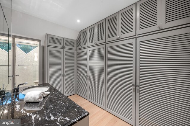 interior space featuring recessed lighting, a sink, and wood finished floors