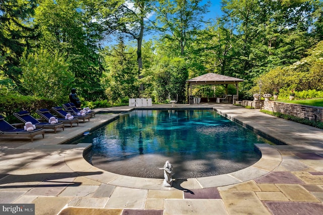 pool featuring a gazebo and a patio