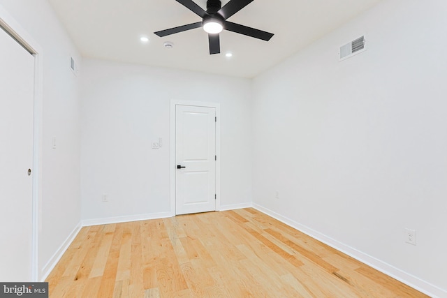 unfurnished room with a ceiling fan, recessed lighting, light wood-style flooring, and baseboards