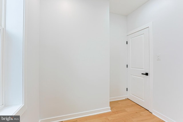 interior space with light wood finished floors and baseboards