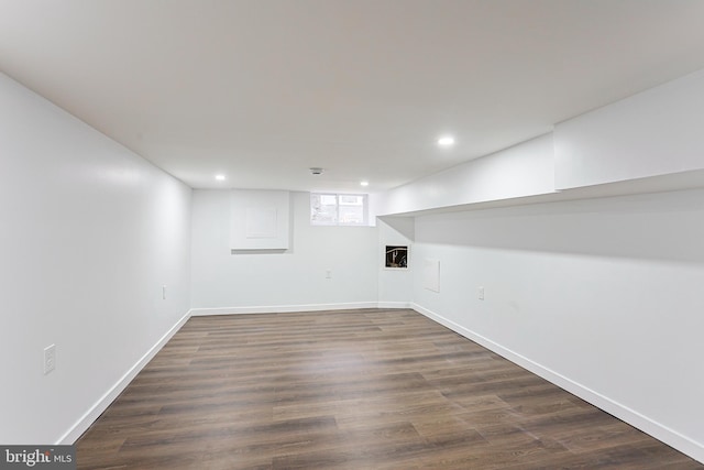 basement with dark wood-style floors, baseboards, and recessed lighting