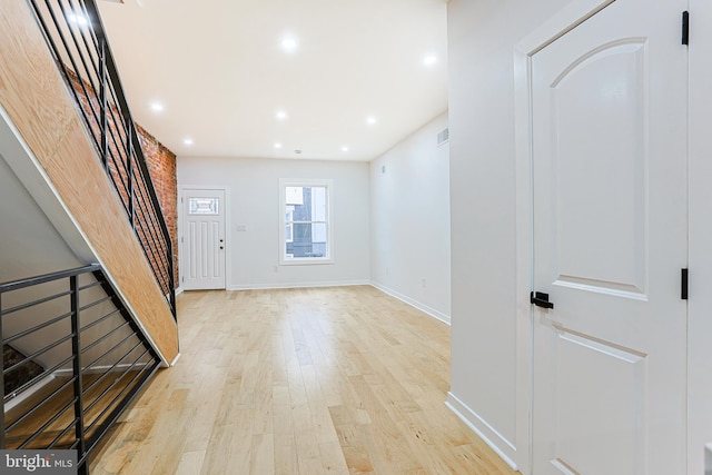 entryway featuring recessed lighting, visible vents, baseboards, stairs, and light wood finished floors