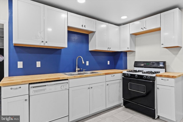 kitchen with range with gas stovetop, wood counters, white dishwasher, white cabinetry, and a sink