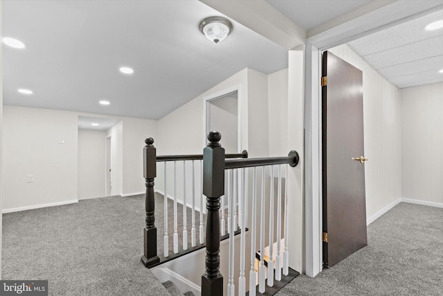 hallway featuring recessed lighting, carpet, an upstairs landing, and baseboards