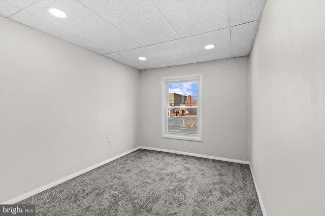 unfurnished room with carpet, a paneled ceiling, baseboards, and recessed lighting