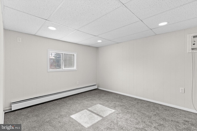 carpeted empty room featuring recessed lighting, a paneled ceiling, and baseboard heating