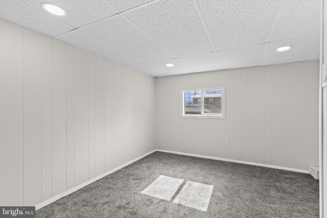 carpeted spare room with recessed lighting, a drop ceiling, and baseboards