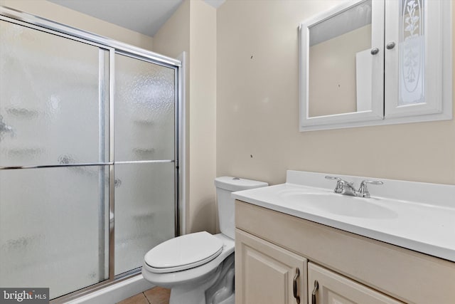 full bath featuring vanity, tile patterned flooring, toilet, and a shower stall