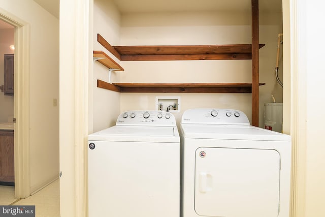 washroom featuring washing machine and clothes dryer and laundry area