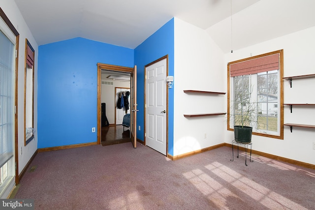 unfurnished bedroom with baseboards, carpet, and lofted ceiling