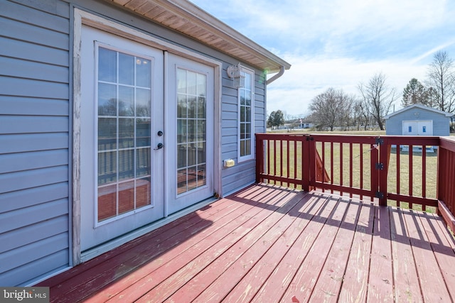 wooden deck with french doors and a lawn