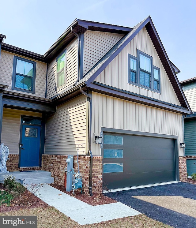 view of front of property featuring brick siding and aphalt driveway