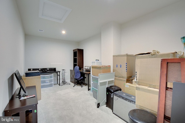 carpeted home office featuring visible vents and attic access