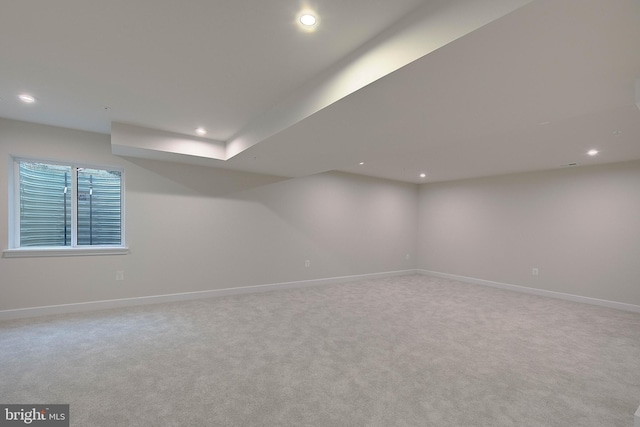 empty room with baseboards, light carpet, and recessed lighting