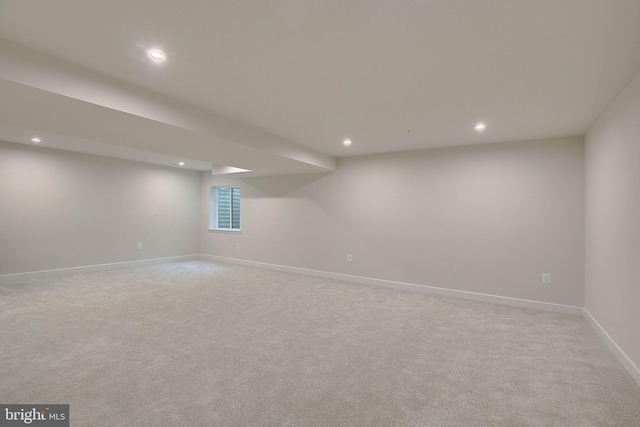 below grade area featuring baseboards, light carpet, and recessed lighting