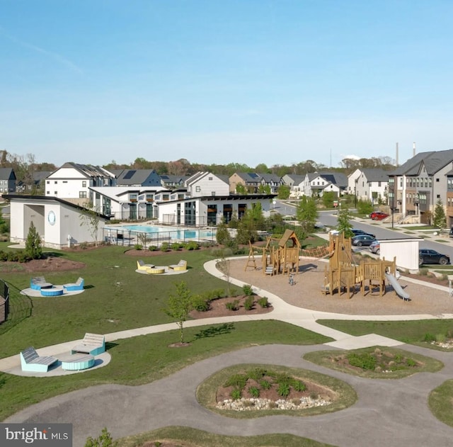 view of property's community featuring a residential view, a swimming pool, and playground community