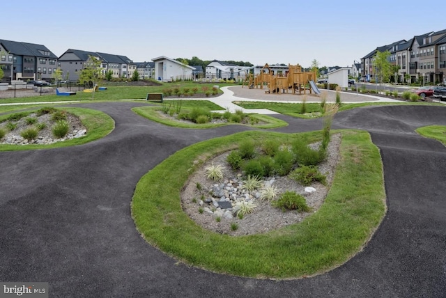 view of property's community with playground community and a residential view