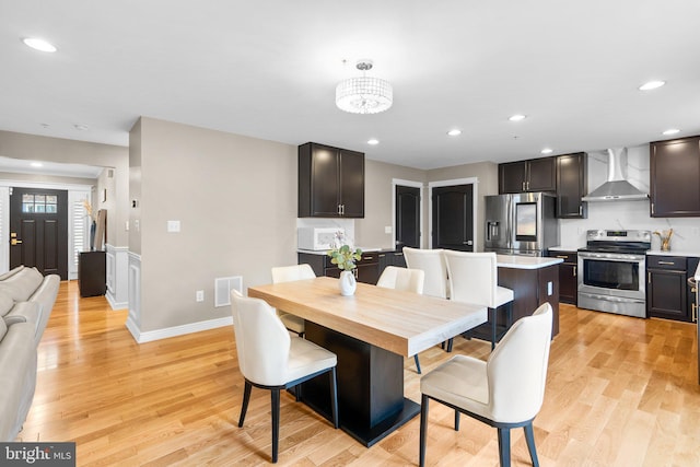 dining area with light wood-style floors, recessed lighting, visible vents, and baseboards