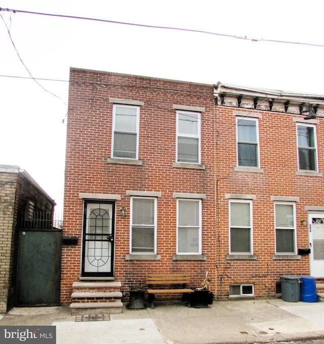 view of front of property featuring entry steps and brick siding