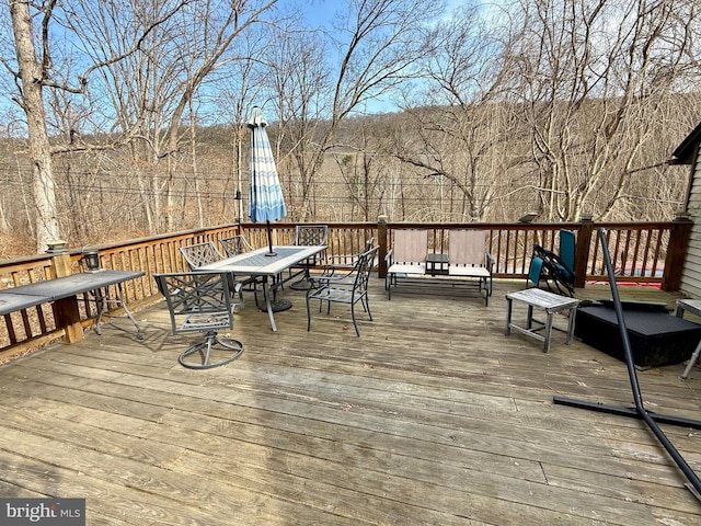 wooden terrace featuring outdoor dining space