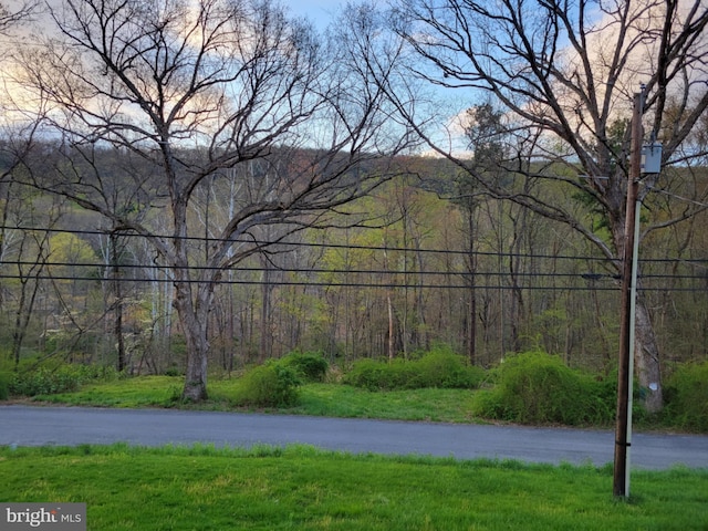 exterior space featuring a wooded view