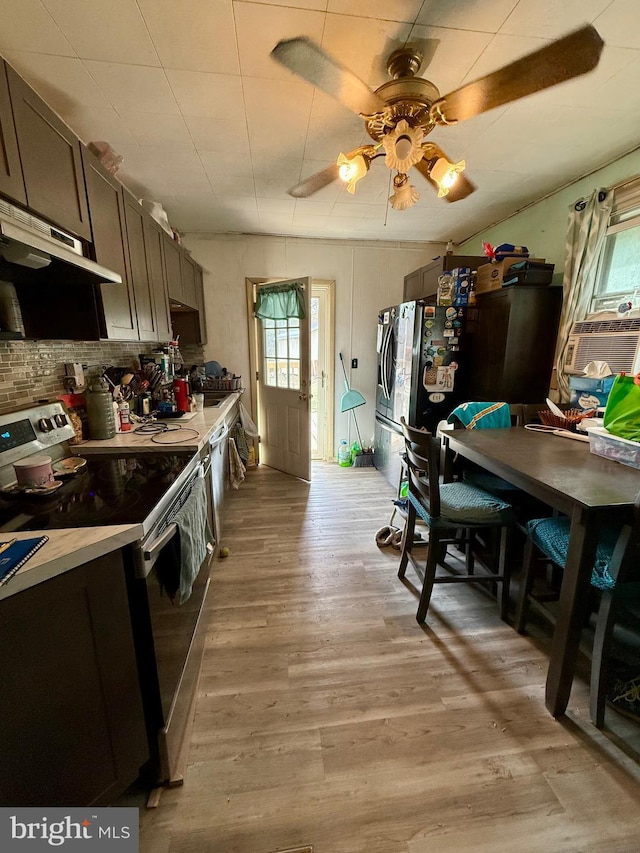 kitchen featuring ceiling fan, light countertops, decorative backsplash, light wood-style flooring, and electric stove