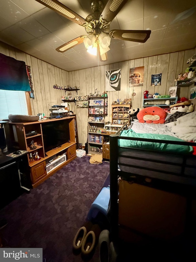 carpeted bedroom with wood walls