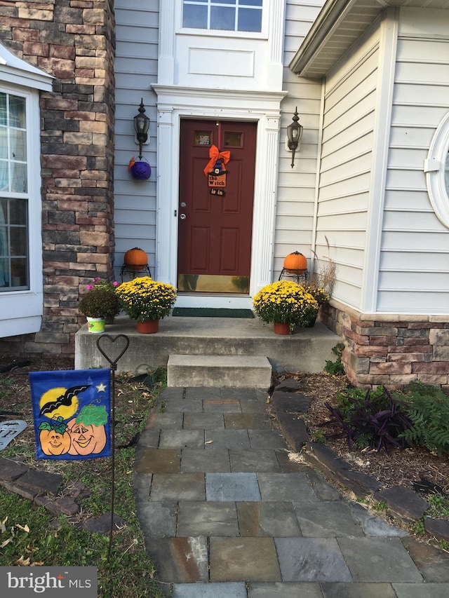 entrance to property featuring stone siding