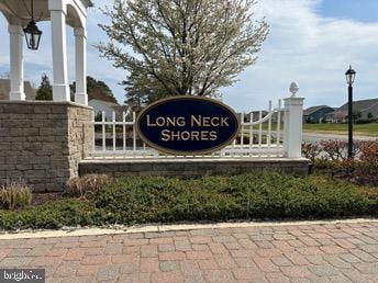 community / neighborhood sign with a gate