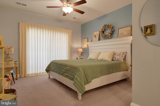 carpeted bedroom featuring visible vents and a ceiling fan