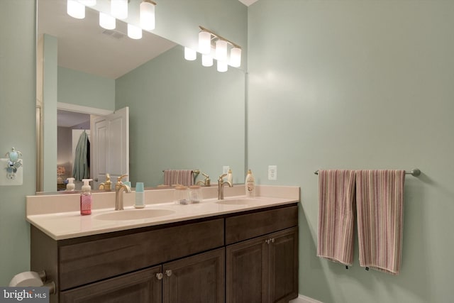 bathroom featuring double vanity, visible vents, and a sink