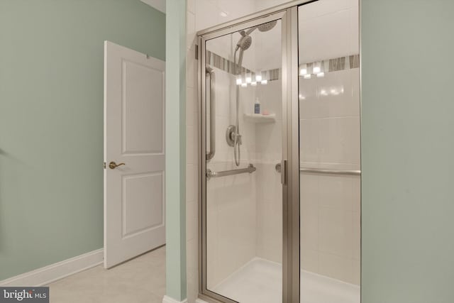 bathroom featuring a stall shower and baseboards